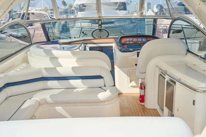 Slide: The Image of Luxurious interior of a 2000 Sunseeker Camargue 50 yacht with white seating and control panel. - 43