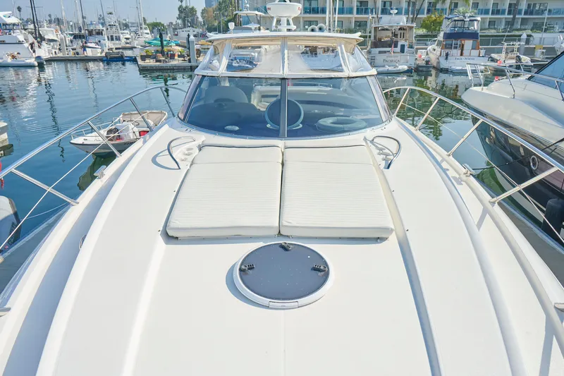 Slide: The Image of Sunseeker Camargue 50 yacht, 2000 model, docked in a marina with sunbathing area. - 45