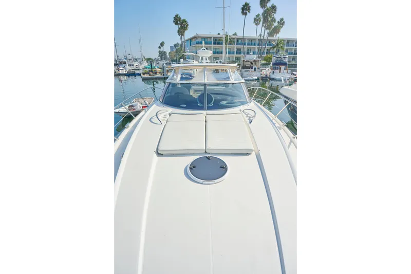 Slide: The Image of Sunseeker Camargue 50 yacht, 2000 model, docked in a marina with palm trees. - 46