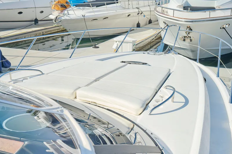 Slide: The Image of Sunseeker Camargue 50 yacht, 2000 model, docked with sunbathing area visible. - 47