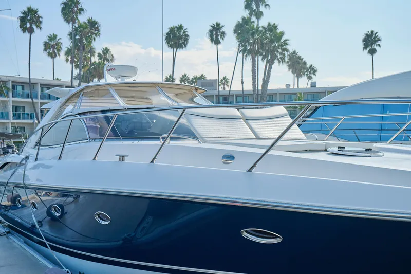 Slide: The Image of Luxury Sunseeker Camargue 50 yacht docked, surrounded by palm trees, 2000 model. - 51