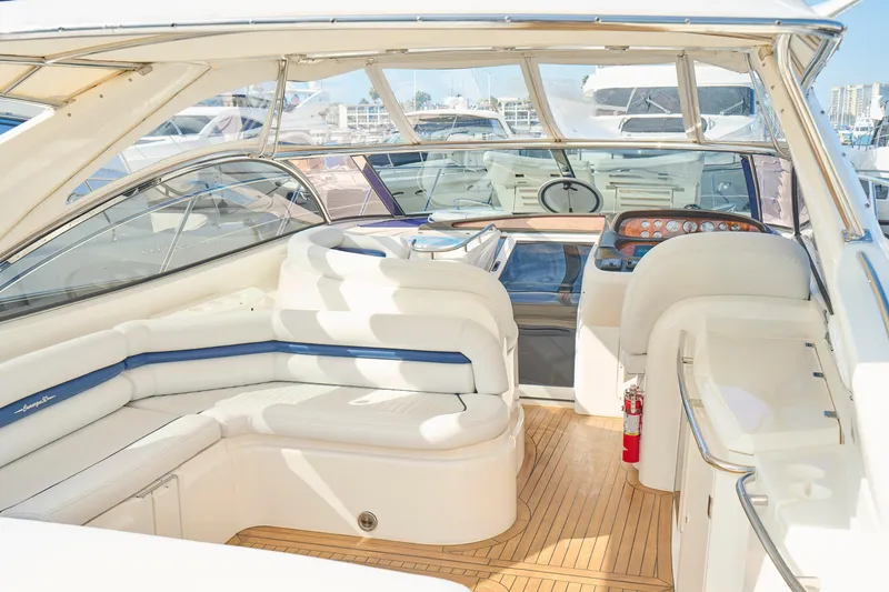 Slide: The Image of Luxurious Sunseeker Camargue 50 yacht interior, featuring elegant white seating and modern dashboard. - 55