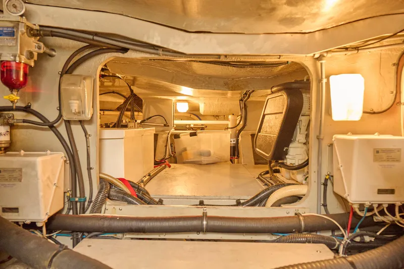 Slide: The Image of Engine room of 2000 Sunseeker Camargue 50 yacht, showcasing mechanical components and wiring. - 58