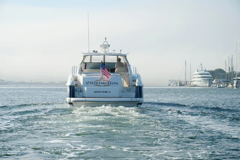 Slide: The Image of Sunseeker Camargue 50 yacht cruising in Newport Beach harbor, 2000 model, with American flag. - 7