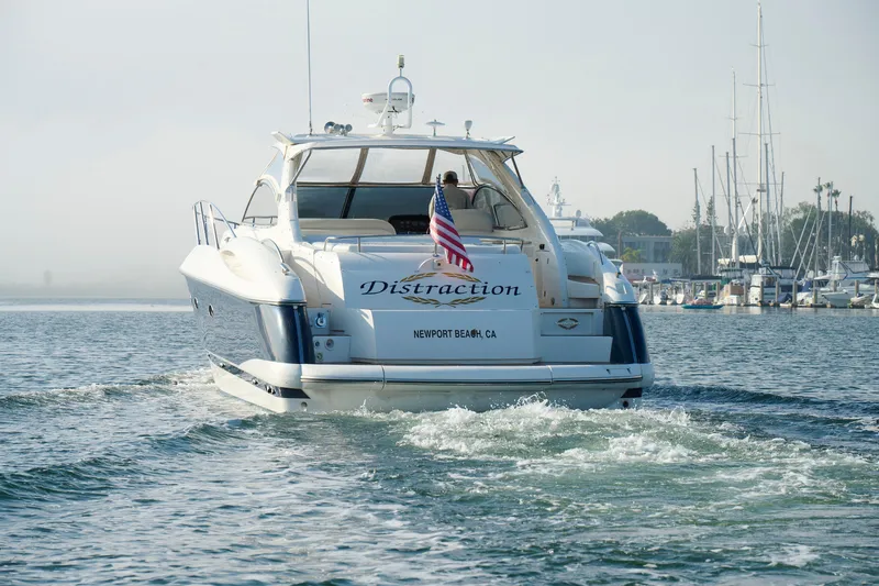 Slide: The Image of Sunseeker Camargue 50 yacht cruising in Newport Beach, 2000 model, with American flag. - 8