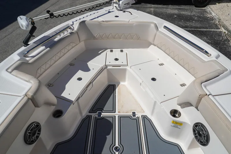 Slide: The Image of 2021 Blue Wave Boats Makaira interior with cushioned seating and storage compartments. - 10