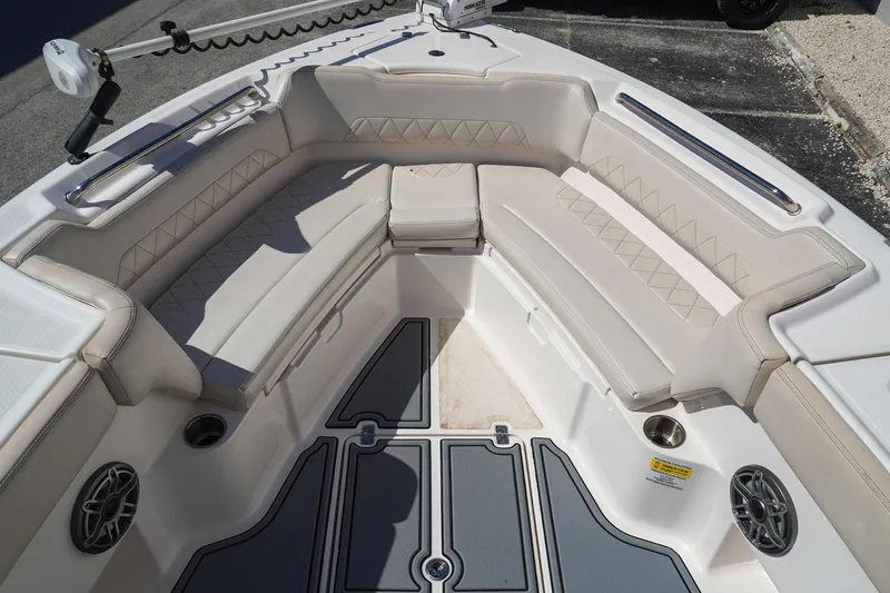 Slide: The Image of 2021 Blue Wave Boats Makaira interior with cushioned seating and cup holders. - 11