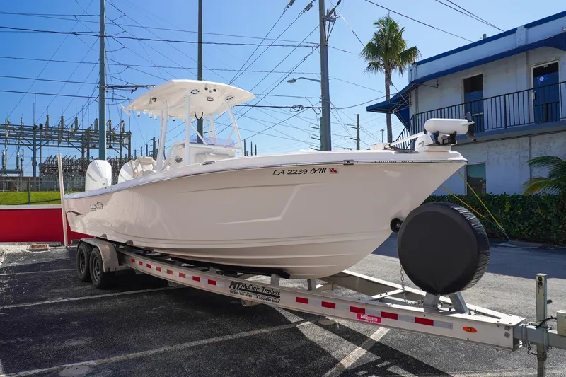 Slide: The Image of 2021 Blue Wave Boats Makaira on trailer, parked outdoors under clear sky. - 3