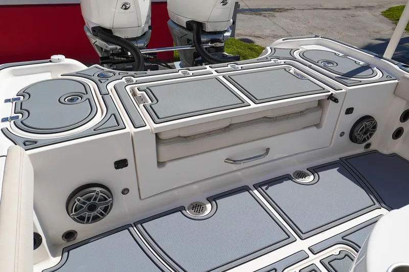 Slide: The Image of 2021 Blue Wave Boats Makaira deck with storage compartments and dual engines. - 5