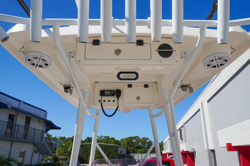 Slide: The Image of 2021 Blue Wave Boats Makaira T-top with speakers and storage compartments. - 8