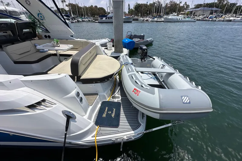 Slide: The Image of 2020 Monterey 355 Sport Yacht docked with inflatable boat, marina background. - 14