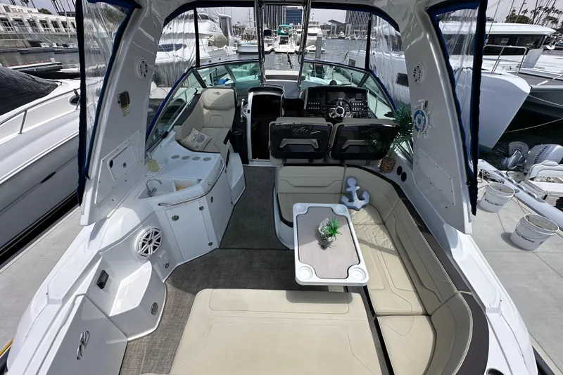 Slide: The Image of Luxurious 2020 Monterey 355 Sport Yacht interior with seating and helm, docked at marina. - 17