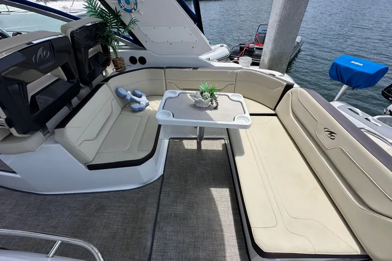 Slide: The Image of Luxury seating area on a 2020 Monterey 355 Sport Yacht with table and decor. - 19