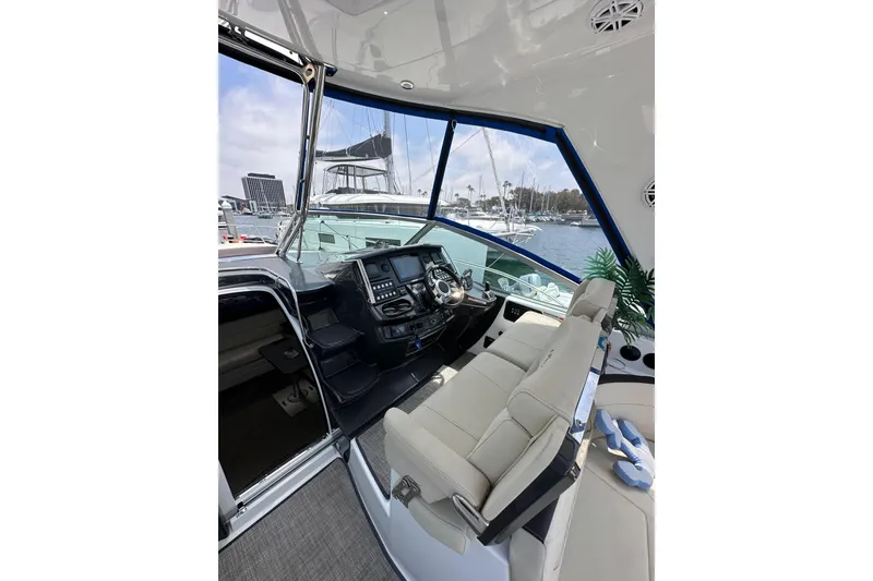 Slide: The Image of Interior of 2020 Monterey 355 Sport Yacht with helm and seating, docked at marina. - 26