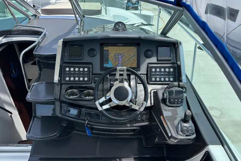 Slide: The Image of Cockpit of 2020 Monterey 355 Sport Yacht with navigation controls and steering wheel. - 28