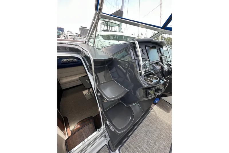 Slide: The Image of 2020 Monterey 355 Sport Yacht helm with modern controls and cabin entrance. - 30