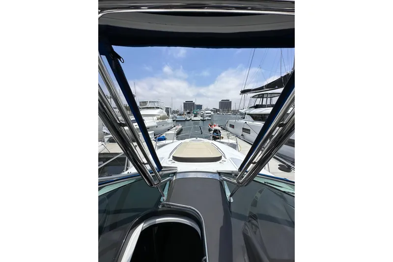 Slide: The Image of 2020 Monterey 355 Sport Yacht docked in a marina, surrounded by other boats. - 31