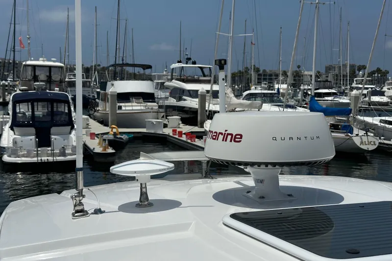 Slide: The Image of 2020 Monterey 355 Sport Yacht docked in a marina with other boats. - 34