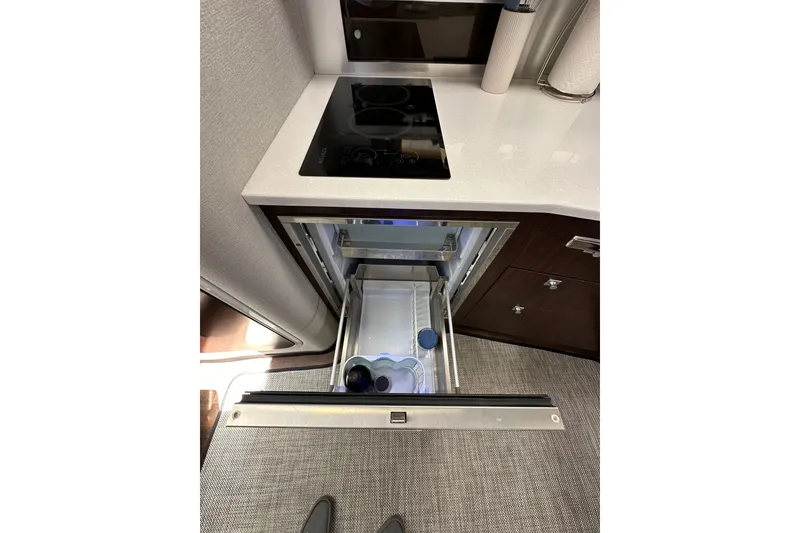 Slide: The Image of Modern kitchen area in 2020 Monterey 355 Sport Yacht with open drawer and cooktop. - 40