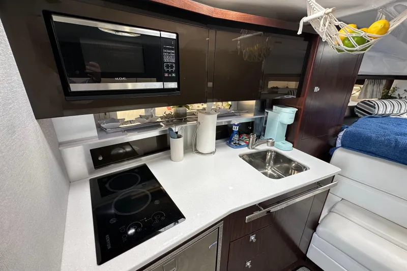 Slide: The Image of Modern kitchen in 2020 Monterey 355 Sport Yacht with microwave, stovetop, and sink. - 41