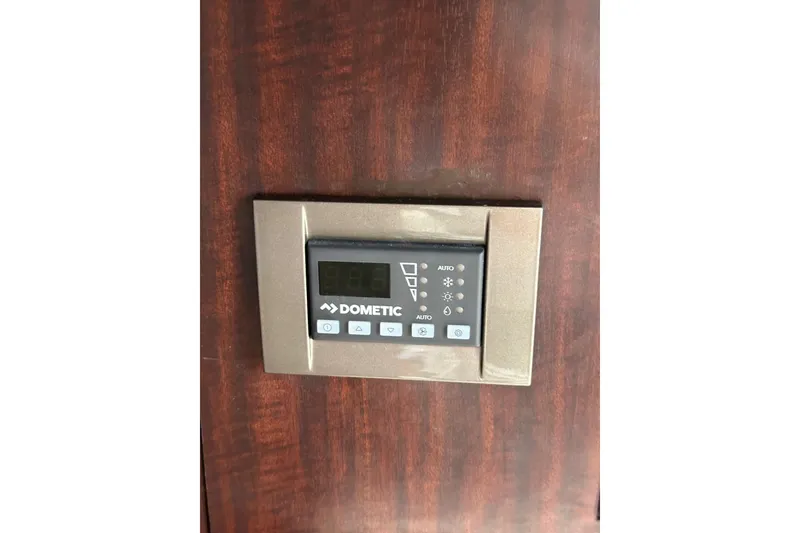 Slide: The Image of Dometic control panel on 2020 Monterey 355 Sport Yacht, mounted on wooden surface. - 48