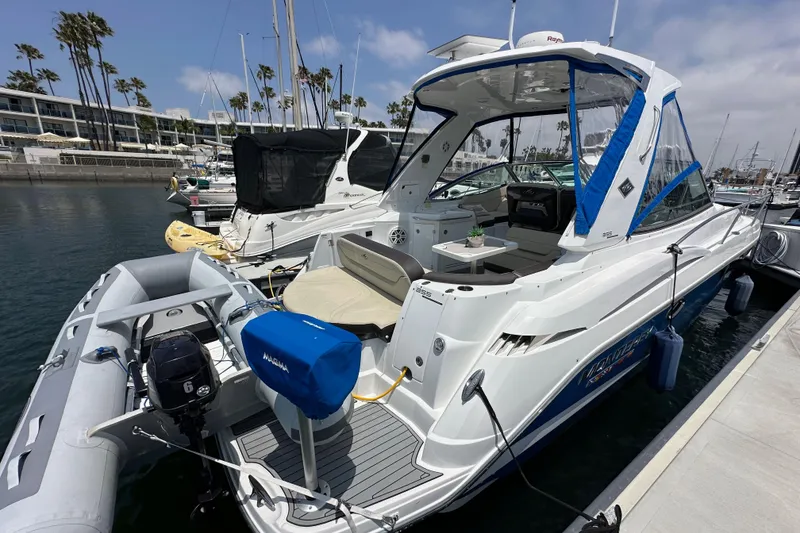 Slide: The Image of 2020 Monterey 355 Sport Yacht docked at marina with inflatable boat attached. - 6