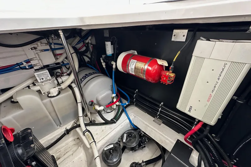 Slide: The Image of Engine compartment of 2020 Monterey 355 Sport Yacht with fire extinguisher and electrical components. - 73