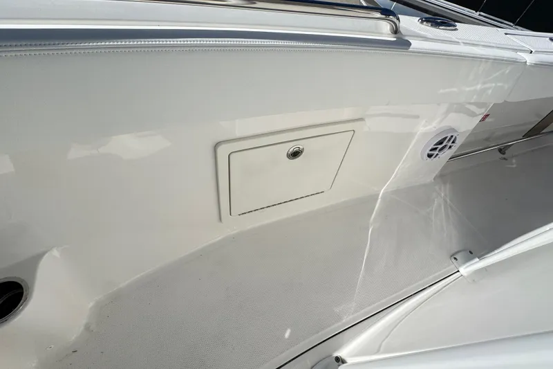 Slide: The Image of 2026 Robalo R230 Center Console boat interior with storage compartment and speaker. - 10