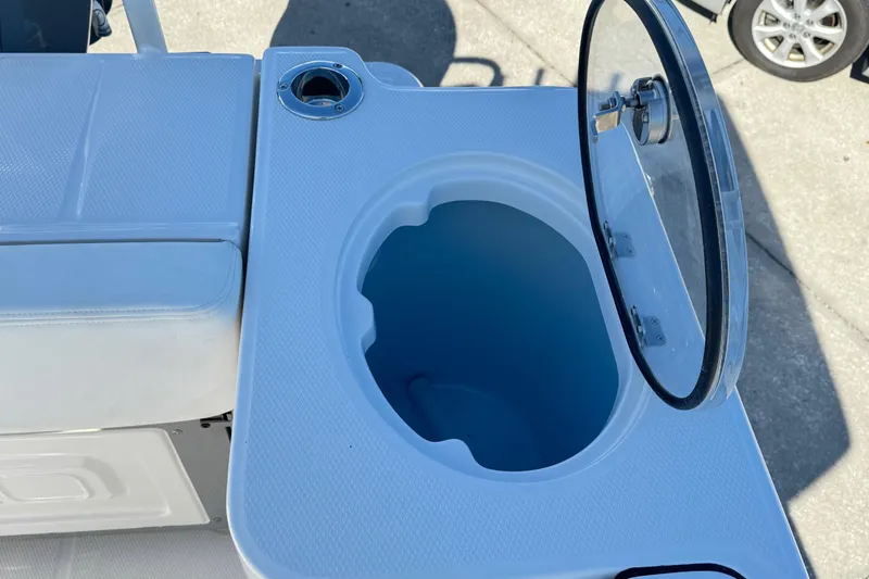 Slide: The Image of 2026 Robalo R230 Center Console boat with open storage compartment and seating. - 12