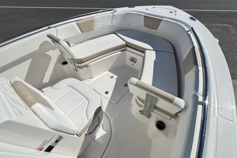 Slide: The Image of 2026 Robalo R230 Center Console boat interior with cushioned seating and storage. - 15