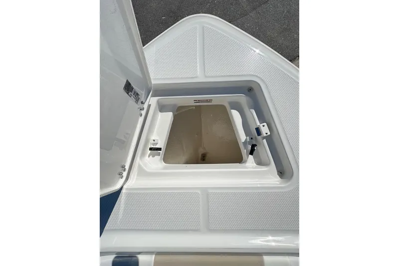 Slide: The Image of Open storage compartment on 2026 Robalo R230 Center Console boat. - 16