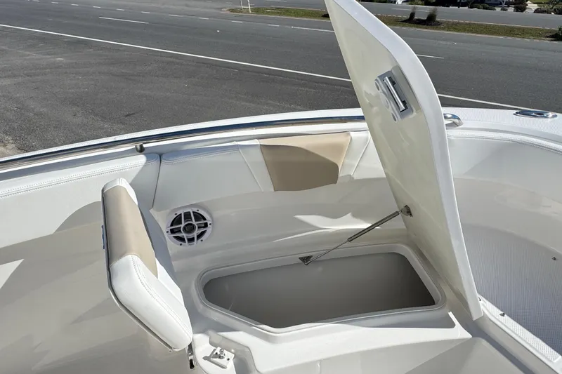 Slide: The Image of 2026 Robalo R230 Center Console boat with open storage compartment and seating. - 20
