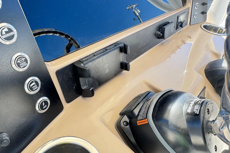 Slide: The Image of 2026 Robalo R230 Center Console dashboard with controls and phone holder. - 22