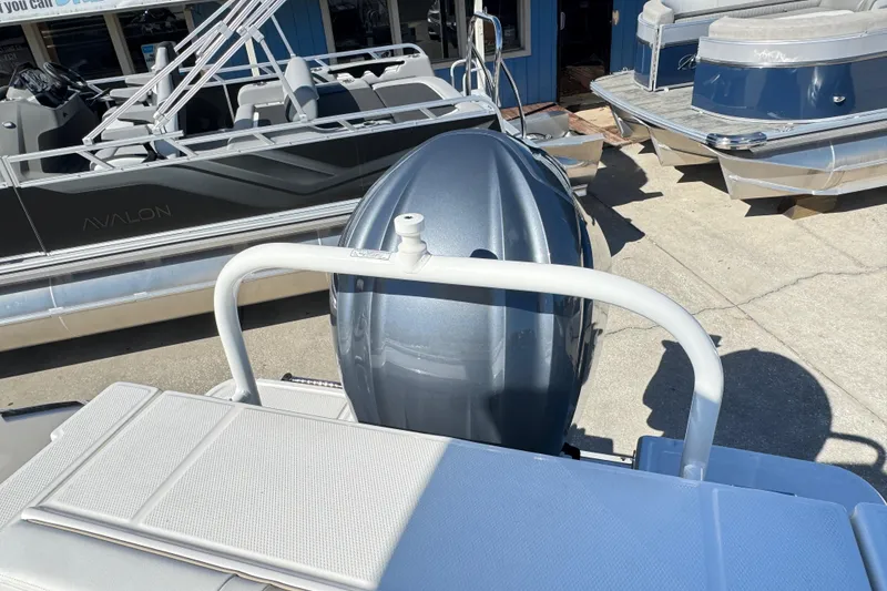 Slide: The Image of 2026 Robalo R230 Center Console boat with outboard motor, displayed at a marina. - 25