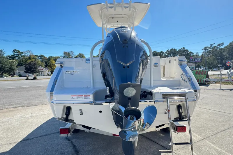 Slide: The Image of 2026 Robalo R230 Center Console boat with powerful outboard motor, parked outdoors. - 4