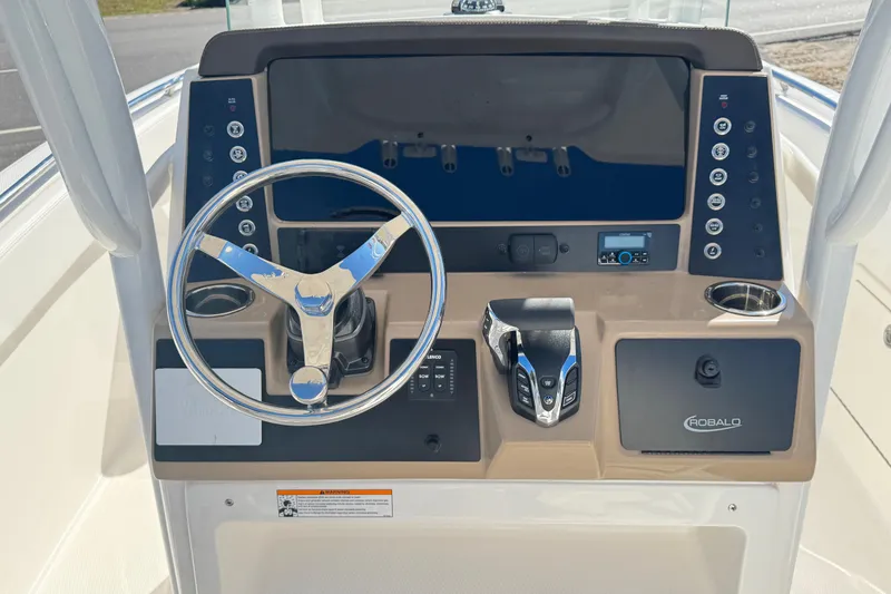 Slide: The Image of 2026 Robalo R230 Center Console boat dashboard with steering wheel and controls. - 5
