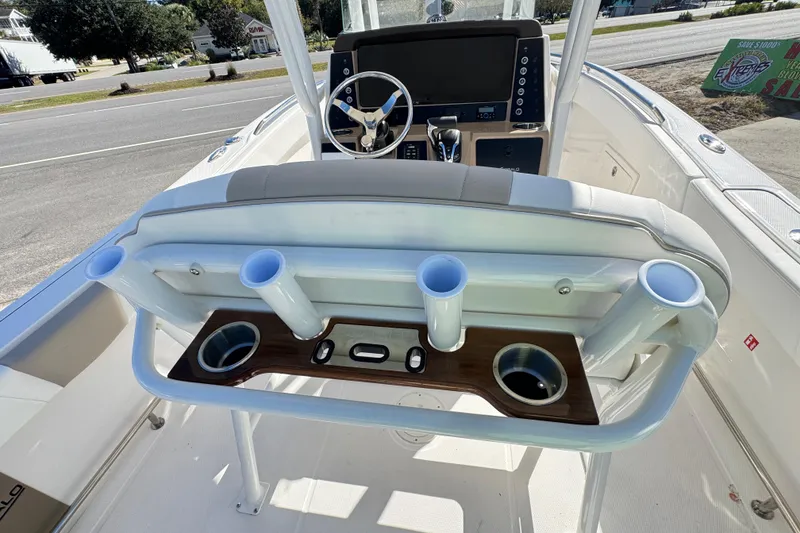 Slide: The Image of 2026 Robalo R230 Center Console boat interior with rod holders and steering console. - 6
