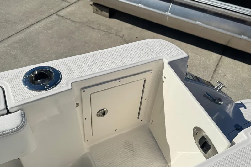 Slide: The Image of 2026 Robalo R230 Center Console boat interior with storage compartment and rod holder. - 8