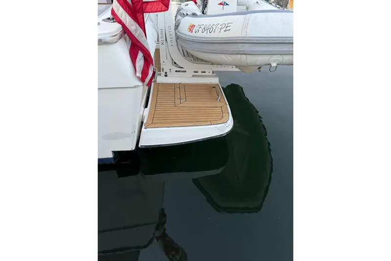 Slide: The Image of 1998 Bayliner 4788 Pilot House Motoryacht deck with table, chairs, and wine setup. - 10