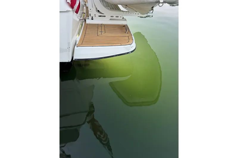 Slide: The Image of 1998 Bayliner 4788 Pilot House Motoryacht with blue underwater lights at dock. - 12