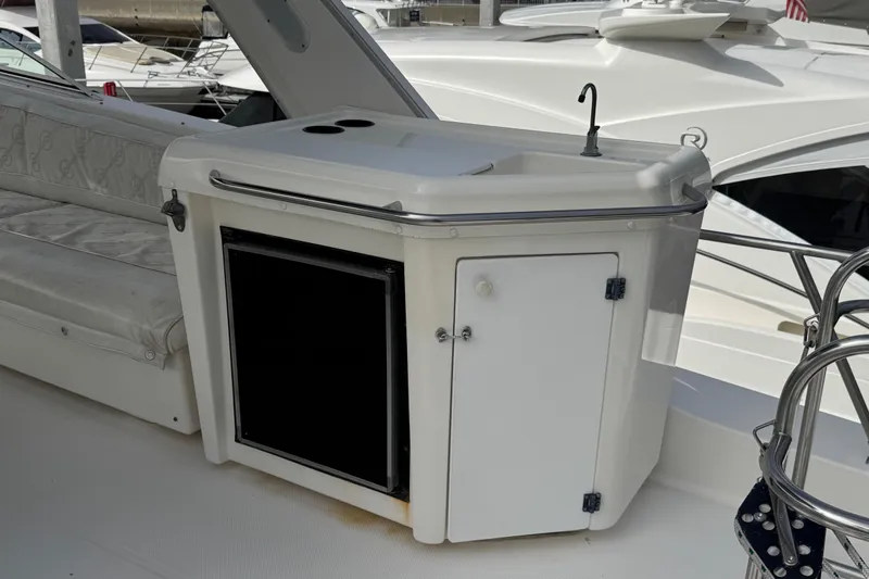 Slide: The Image of 1998 Bayliner 4788 Pilot House Motoryacht interior with seating and helm, docked at marina. - 15