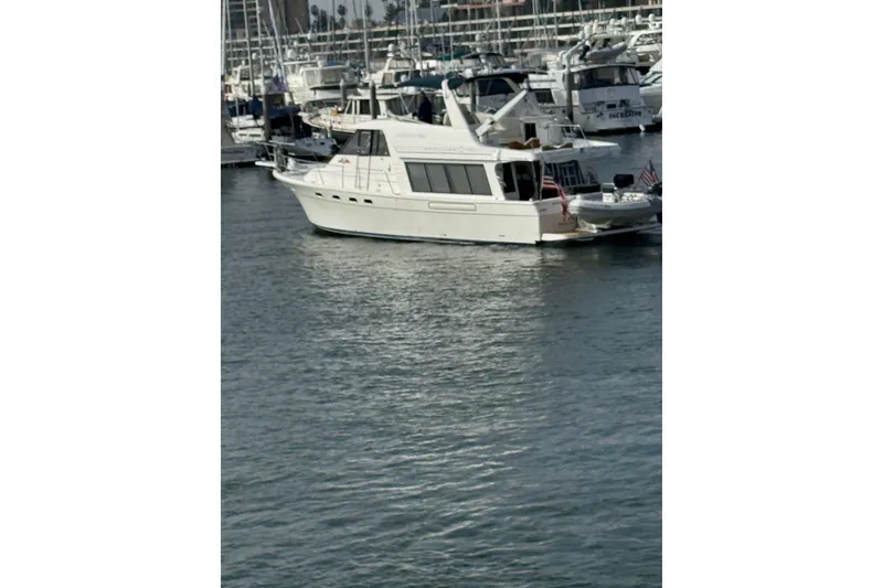 Slide: The Image of 1998 Bayliner 4788 Pilot House Motoryacht docked in a marina. - 2