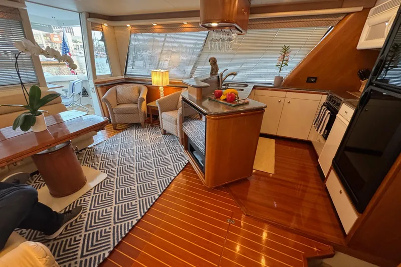 Slide: The Image of Interior of 1998 Bayliner 4788 Pilot House Motoryacht with cozy seating and modern kitchen. - 23