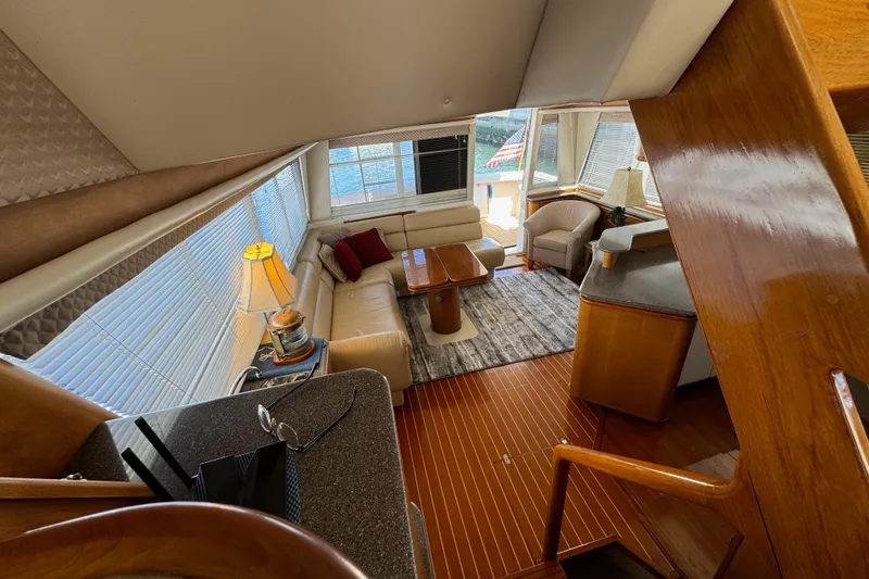 Slide: The Image of Interior of 1998 Bayliner 4788 Pilot House Motoryacht with elegant seating and wooden finishes. - 25