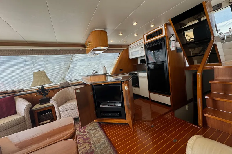 Slide: The Image of Luxurious interior of 1998 Bayliner 4788 Pilot House Motoryacht with modern kitchen and seating area. - 26