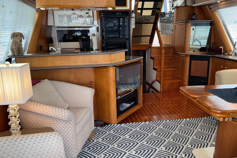 Slide: The Image of Luxurious interior of 1998 Bayliner 4788 Pilot House Motoryacht with elegant wood finishes. - 28