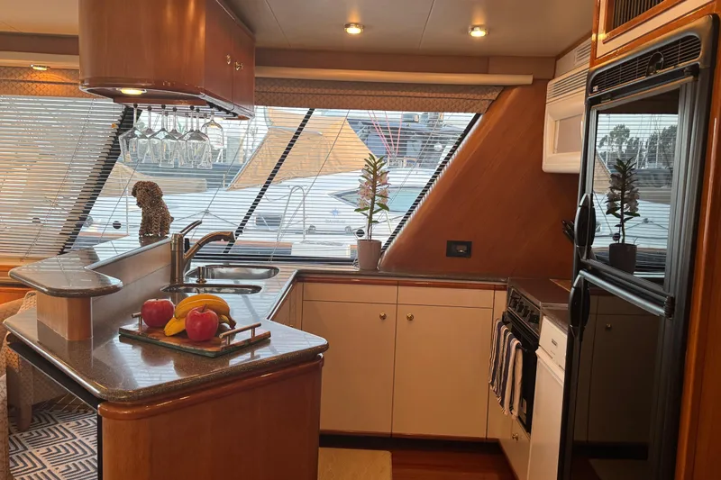Slide: The Image of Luxurious kitchen interior of 1998 Bayliner 4788 Pilot House Motoryacht with modern amenities. - 29