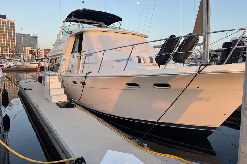 Slide: The Image of 1998 Bayliner 4788 Pilot House Motoryacht docked at marina during sunset. - 3