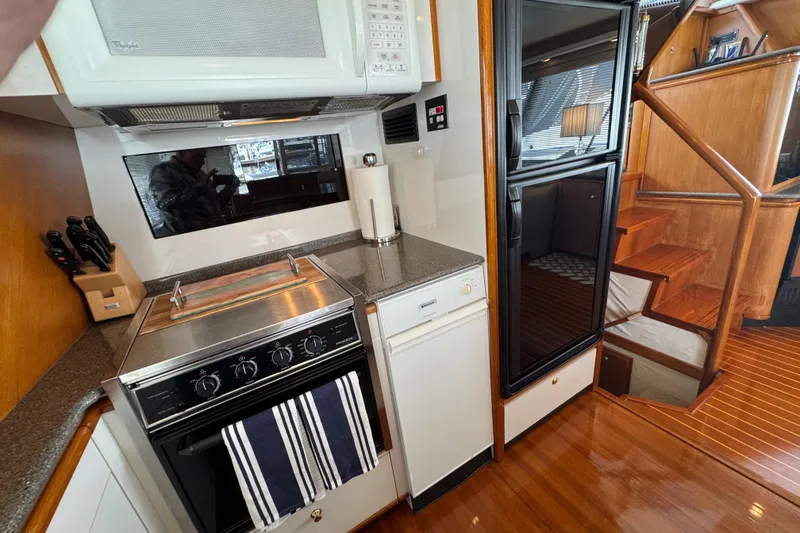 Slide: The Image of Compact kitchen in 1998 Bayliner 4788 Pilot House Motoryacht with stove and modern appliances. - 31