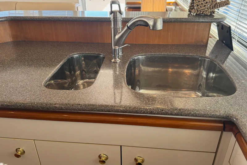 Slide: The Image of 1998 Bayliner 4788 Pilot House Motoryacht interior with helm, seating, and marina view. - 34